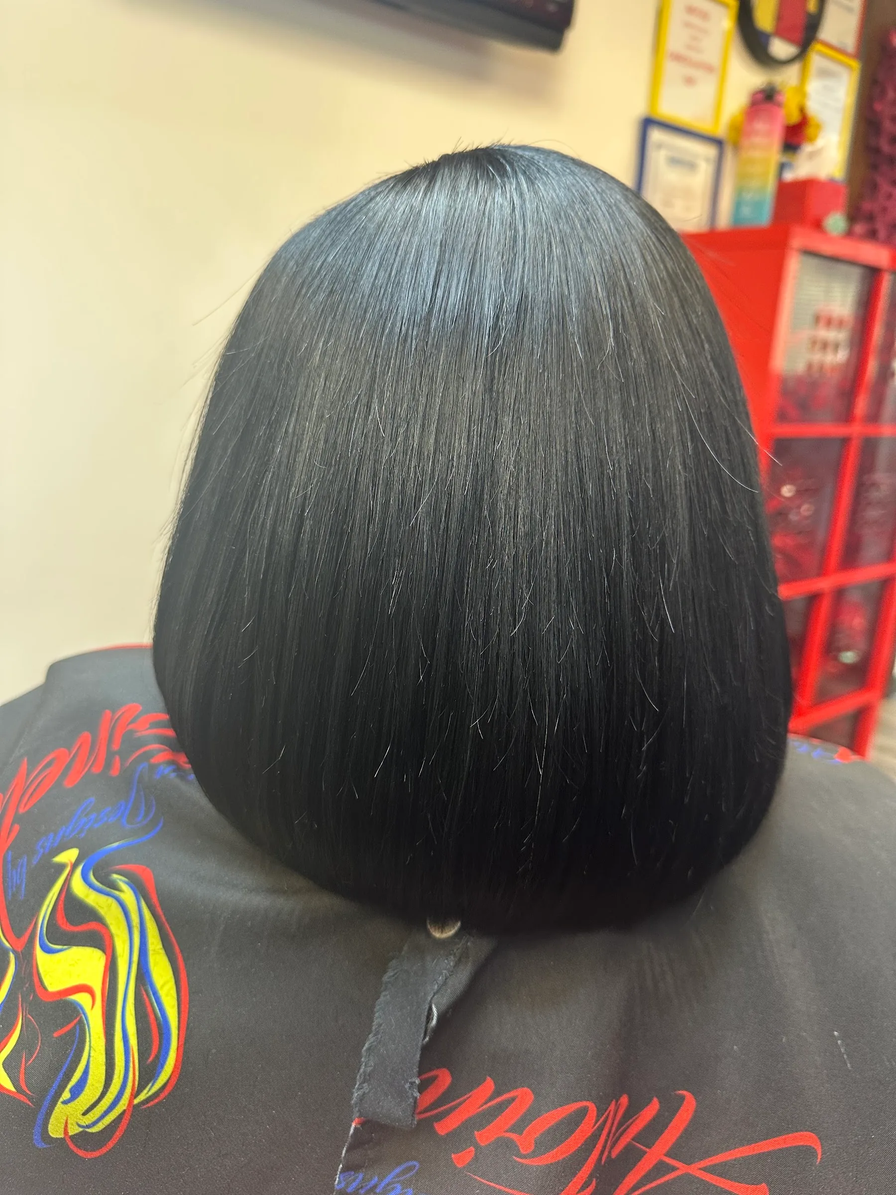 Rear view of a smooth dark chin-length bob