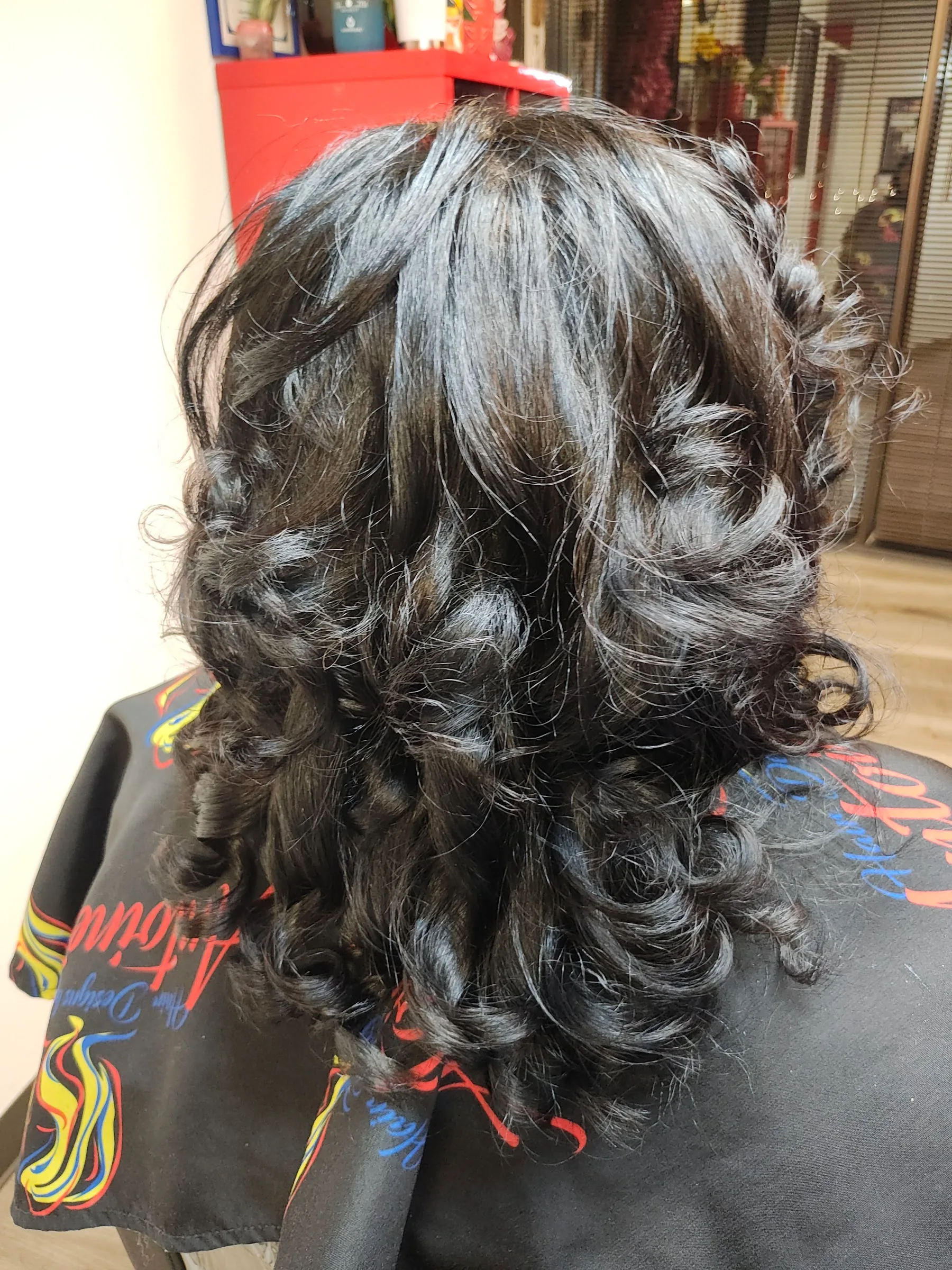 Rear view of layered shoulder-length curls