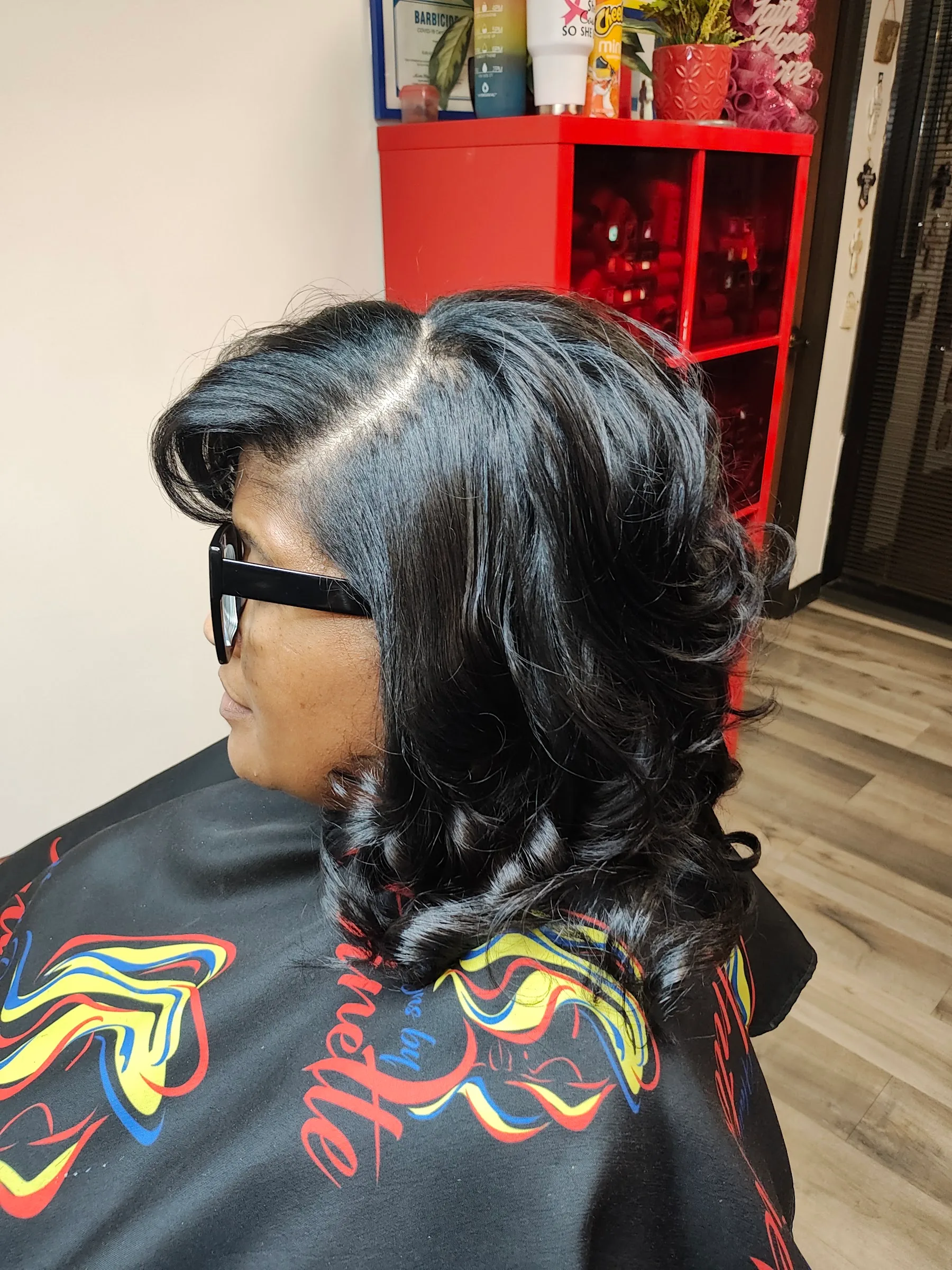 Side view of glossy shoulder-length curls in the salon